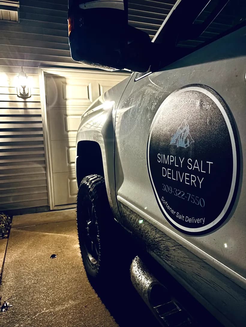 Simply Salt Delivery truck with company decal parked in a customer's driveway in Peoria, Illinois